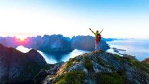 Arms raised on a mountain