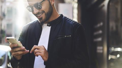 Man looking at mobile phone smiling