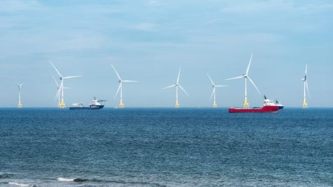 Windmills and ships in the sea