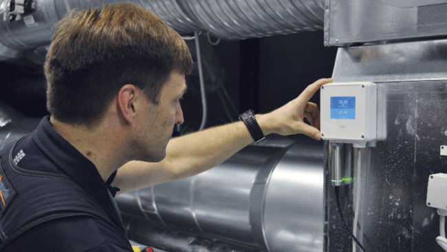 Engineer checking transmitter readings