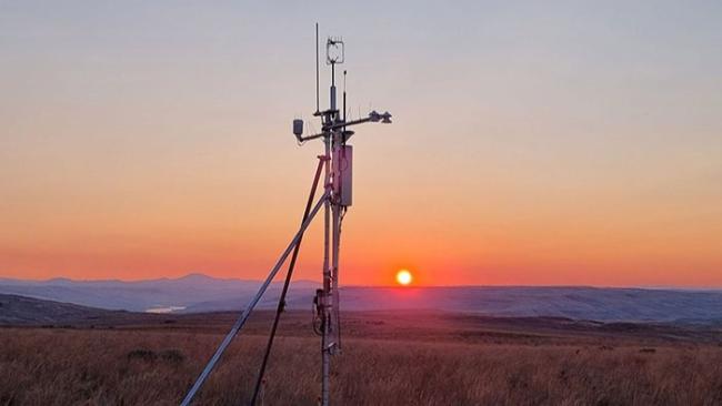 Ecosystem monitoring device with sunset in the background.